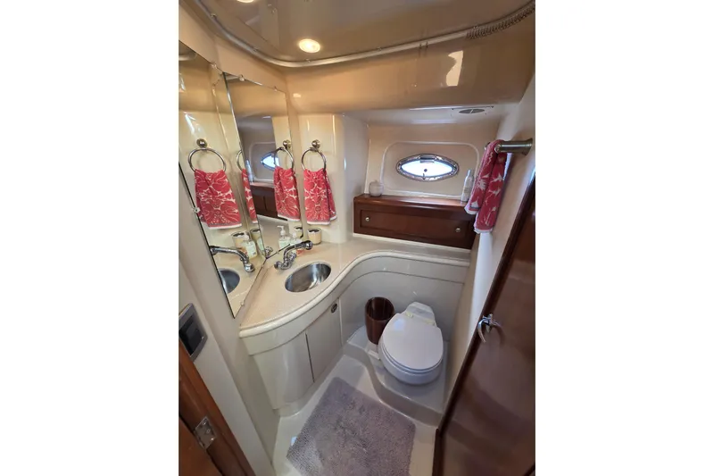 Soul Mates Yacht Photos Pics Luxurious bathroom in 2005 Meridian 411 Sedan yacht with elegant fixtures and red towels.