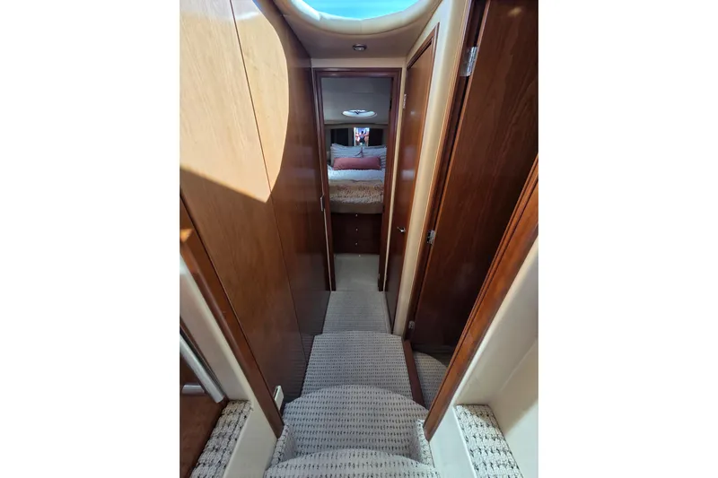 Soul Mates Yacht Photos Pics Interior hallway of 2005 Meridian 411 Sedan yacht with wood paneling and carpeted steps.
