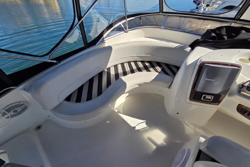 Soul Mates Yacht Photos Pics Interior of 2005 Meridian 411 Sedan yacht with curved seating and navigation equipment.