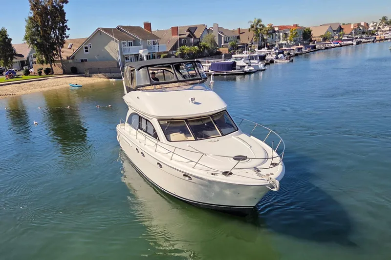 Soul Mates Yacht Photos Pics 2005 Meridian 411 Sedan yacht cruising in a serene residential marina.