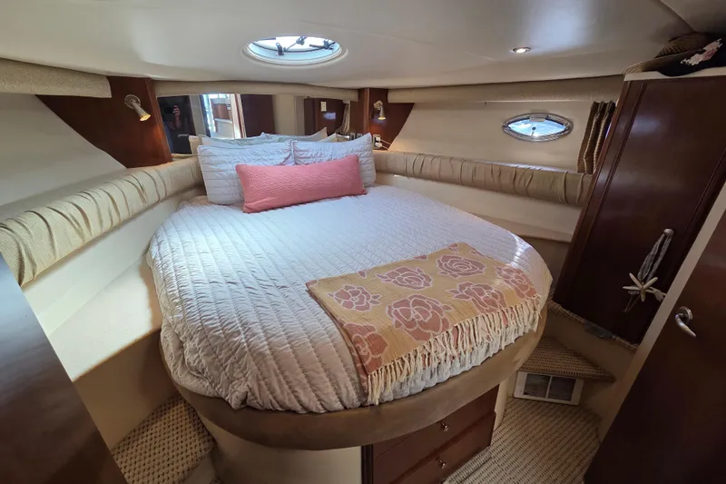 Soul Mates Yacht Photos Pics Luxurious bedroom interior of 2005 Meridian 411 Sedan yacht with cozy bedding and elegant decor.