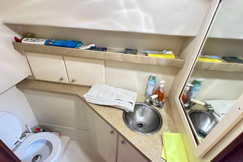  Yacht Photos Pics 2008 Luhrs 31 Hard Top IPS boat bathroom with sink, mirror, and storage cabinets.