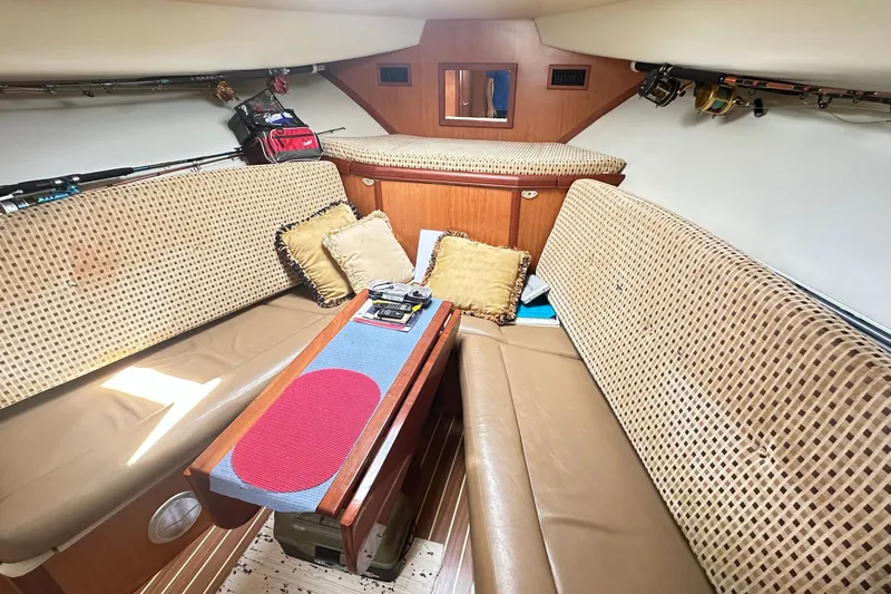  Yacht Photos Pics 2008 Luhrs 31 Hard Top IPS cabin interior with cushioned seating and fishing gear.