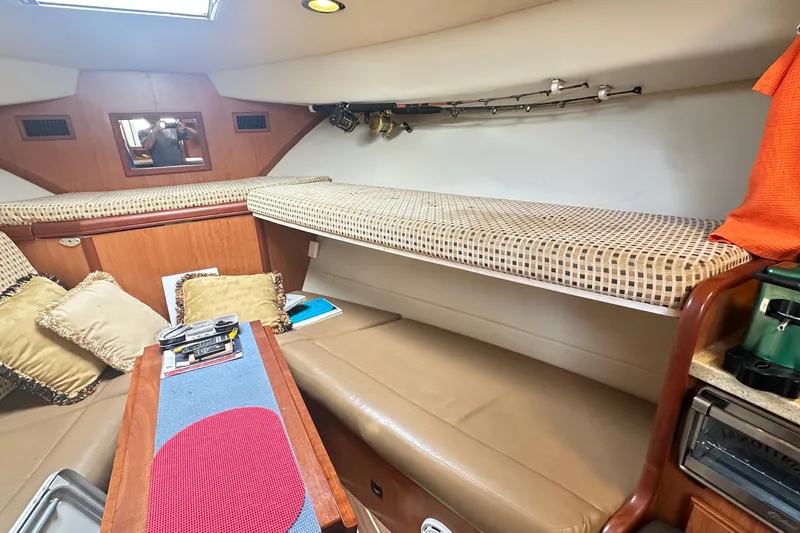  Yacht Photos Pics 2008 Luhrs 31 Hard Top IPS cabin interior with seating, cushions, and fishing rods.
