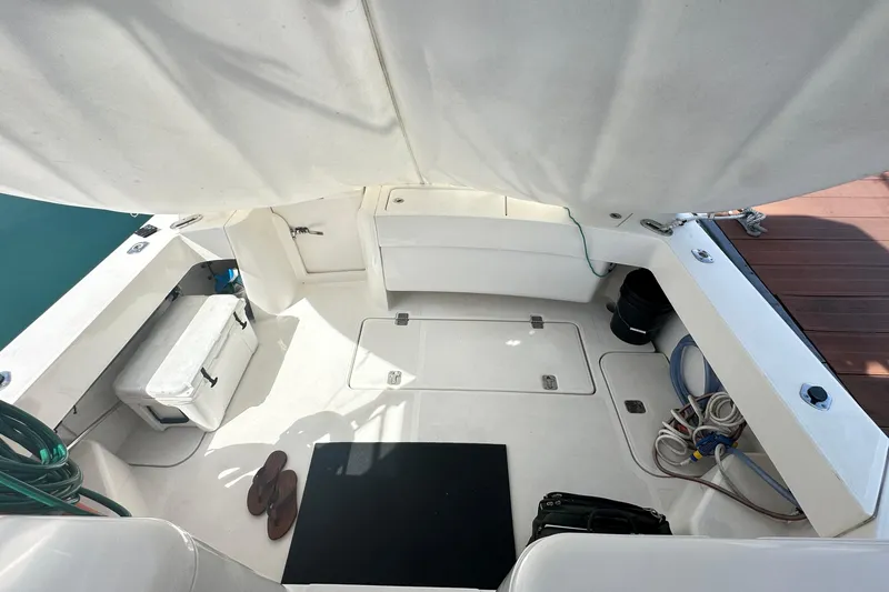  Yacht Photos Pics 2008 Luhrs 31 Hard Top IPS boat deck with storage, cooler, and marine equipment.