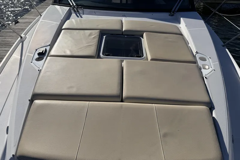 Dancing Queen Yacht Photos Pics Sunpad on 2019 Regal 42 Grande Coupe yacht, featuring beige cushions and sleek design.