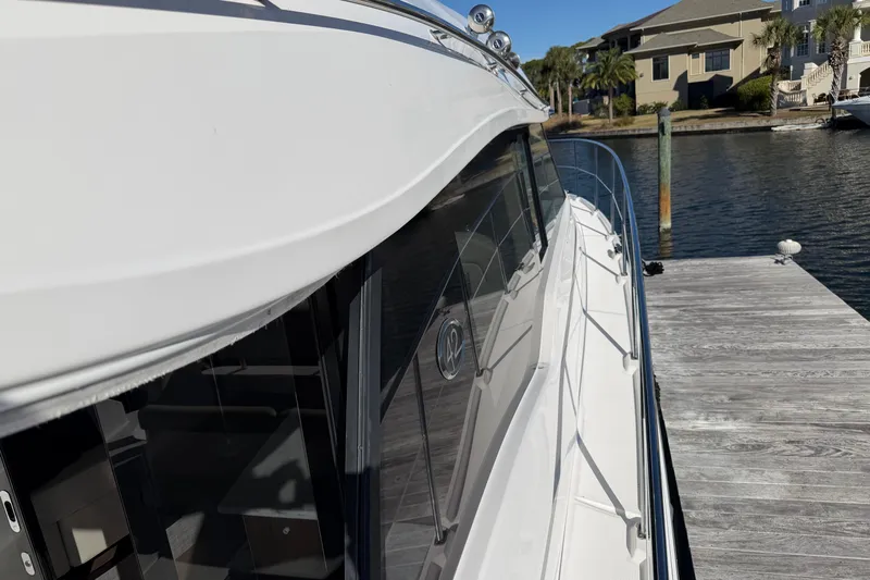 Dancing Queen Yacht Photos Pics 2019 Regal 42 Grande Coupe yacht docked at a marina, side view.