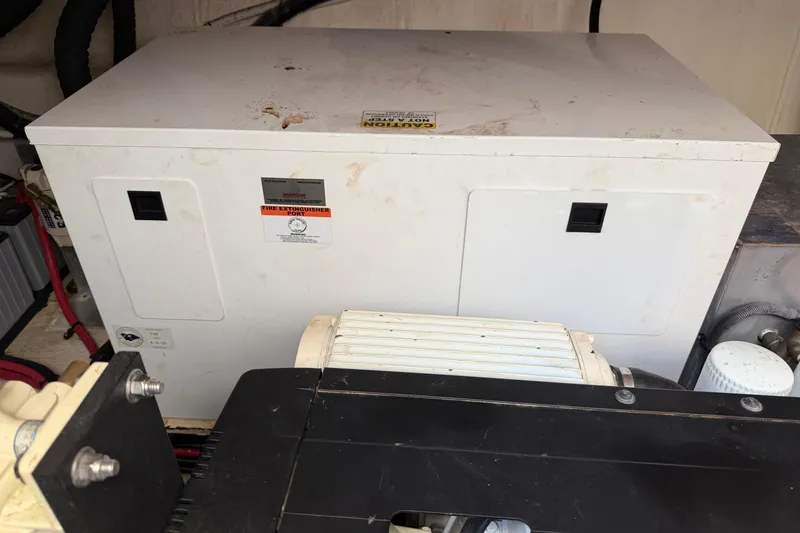 Dancing Queen Yacht Photos Pics Engine compartment of a 2019 Regal 42 Grande Coupe with visible generator and components.