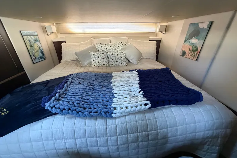 Dancing Queen Yacht Photos Pics Luxurious bedroom interior of 2019 Regal 42 Grande Coupe yacht with cozy bedding.
