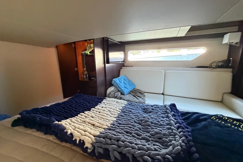 Dancing Queen Yacht Photos Pics Cozy interior cabin of 2019 Regal 42 Grande Coupe with plush bedding and modern design.