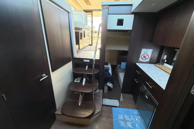 Dancing Queen Yacht Photos Pics Interior of 2019 Regal 42 Grande Coupe yacht with modern kitchen and stairs.