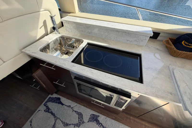 Dancing Queen Yacht Photos Pics Luxurious kitchen area in 2019 Regal 42 Grande Coupe yacht with sink and stove.