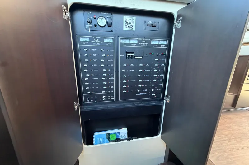 Dancing Queen Yacht Photos Pics Electrical panel inside 2019 Regal 42 Grande Coupe yacht, showcasing switches and controls.