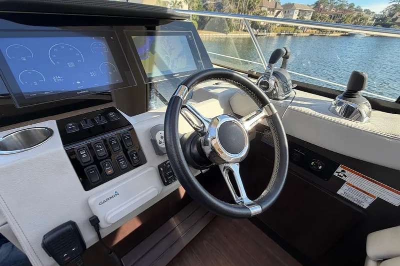 Dancing Queen Yacht Photos Pics Cockpit of 2019 Regal 42 Grande Coupe with steering wheel and navigation displays.