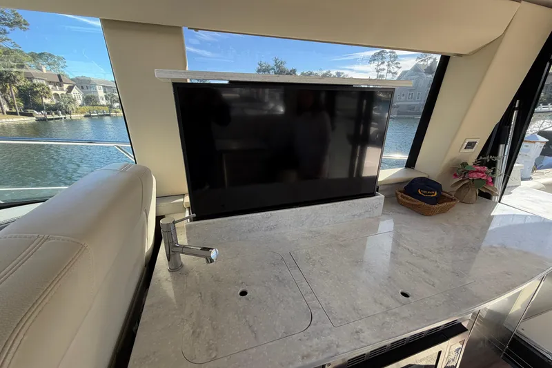 Dancing Queen Yacht Photos Pics Interior of 2019 Regal 42 Grande Coupe with TV and marble countertop.