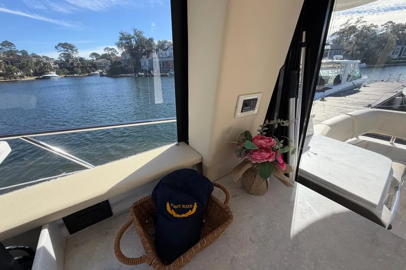 Dancing Queen Yacht Photos Pics Interior view of 2019 Regal 42 Grande Coupe yacht with lake and dockside scenery.