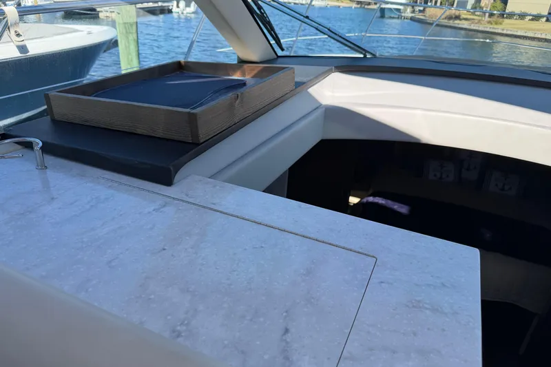 Dancing Queen Yacht Photos Pics 2019 Regal 42 Grande Coupe yacht interior with marble countertop and wooden tray.