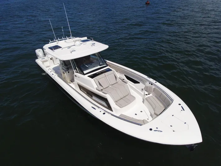 Blue Liner Yacht Photos Pics 2021 Pursuit S 428 Sport boat on open water, aerial view.