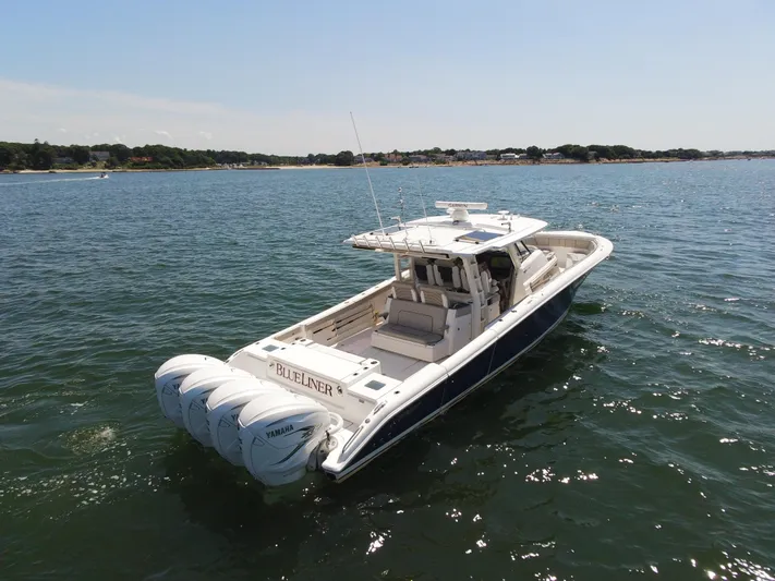 Blue Liner Yacht Photos Pics 2021 Pursuit S 428 Sport boat on open water, featuring four powerful engines.