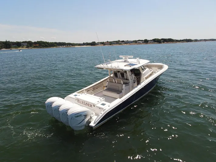 Blue Liner Yacht Photos Pics 2021 Pursuit S 428 Sport boat on open water, featuring four powerful engines.