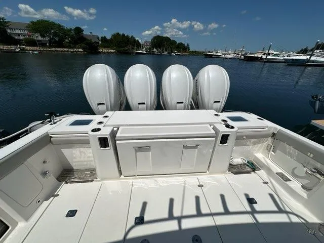Blue Liner Yacht Photos Pics 2021 Pursuit S 428 Sport boat with four powerful outboard engines docked by the water.