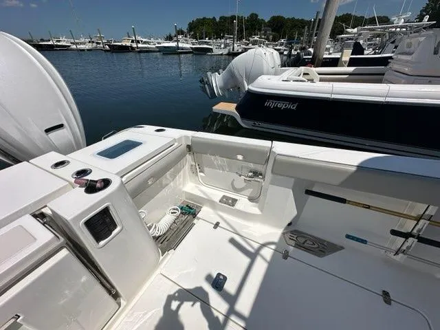 Blue Liner Yacht Photos Pics 2021 Pursuit S 428 Sport boat docked at marina, showcasing spacious deck and equipment.