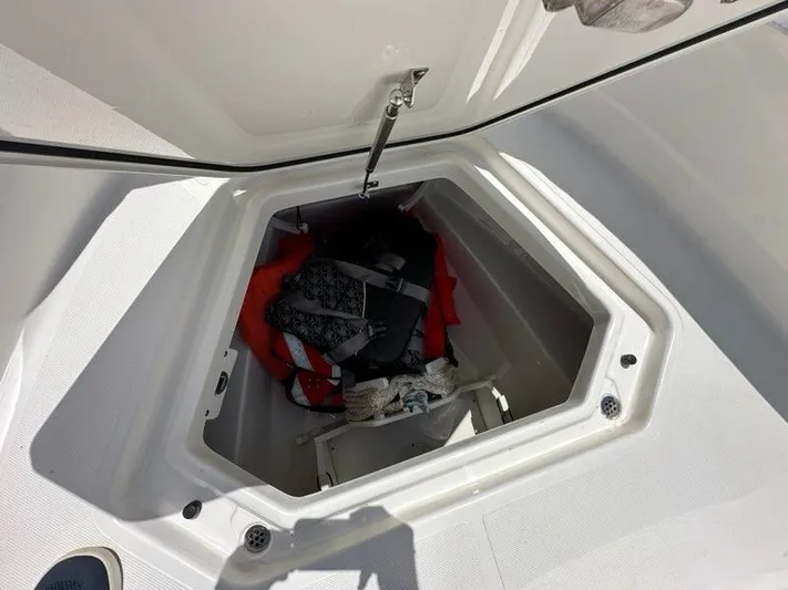 Blue Liner Yacht Photos Pics Storage compartment on 2021 Pursuit S 428 Sport boat with life jackets and gear.