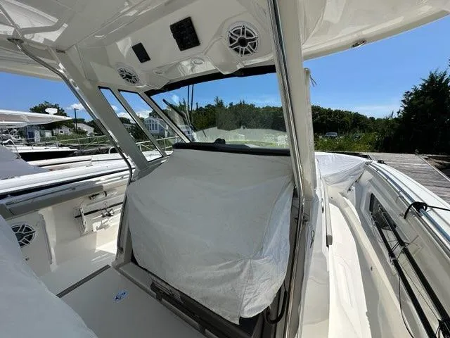 Blue Liner Yacht Photos Pics 2021 Pursuit S 428 Sport boat interior with covered seating and modern design.