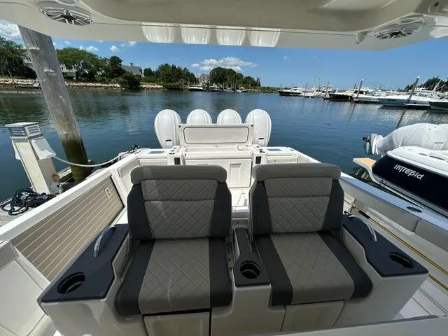 Blue Liner Yacht Photos Pics 2021 Pursuit S 428 Sport boat interior with dual seats, docked in a marina.