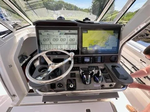 Blue Liner Yacht Photos Pics 2021 Pursuit S 428 Sport boat dashboard with navigation screens and controls.