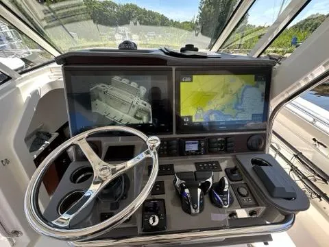 Blue Liner Yacht Photos Pics 2021 Pursuit S 428 Sport boat dashboard with navigation screens and controls.