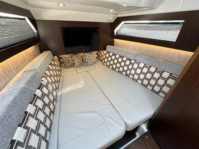 Blue Liner Yacht Photos Pics Luxurious cabin interior of 2021 Pursuit S 428 Sport boat with modern seating and TV.