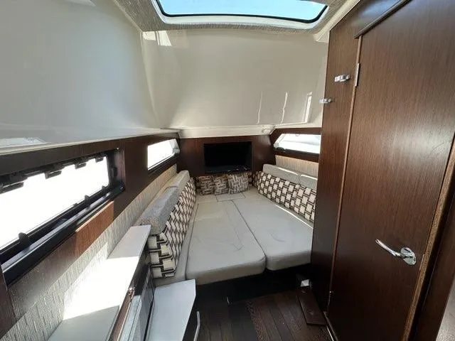 Blue Liner Yacht Photos Pics 2021 Pursuit S 428 Sport cabin interior with modern seating and natural light.