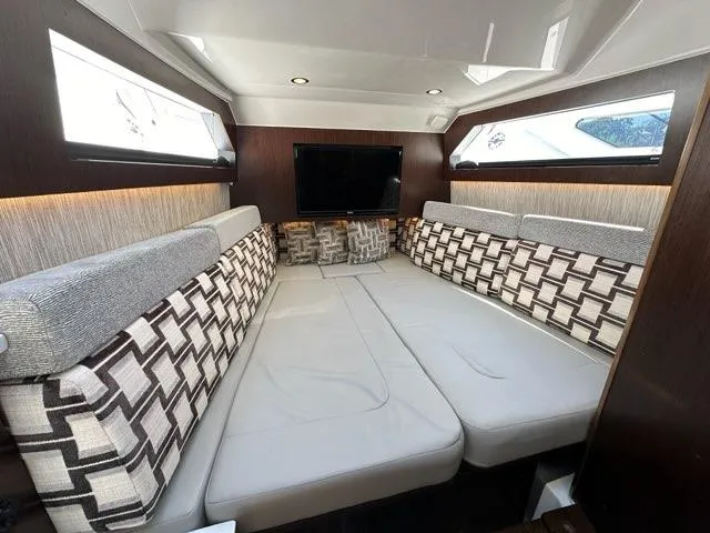 Blue Liner Yacht Photos Pics Luxurious interior cabin of 2021 Pursuit S 428 Sport boat with modern seating and TV.