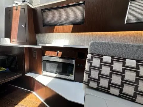 Blue Liner Yacht Photos Pics 2021 Pursuit S 428 Sport interior with modern kitchen and seating area.