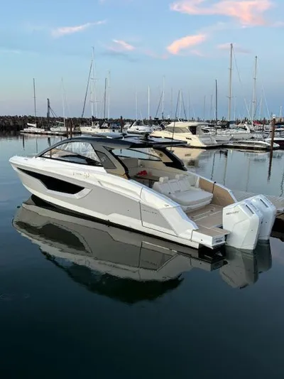  Yacht Photos Pics 2024 Cruisers Yachts 42 GLS in marina, sleek design, calm water reflection.