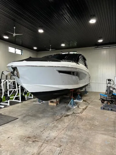  Yacht Photos Pics 2024 Cruisers Yachts 42 GLS in a storage facility, elevated on stands.