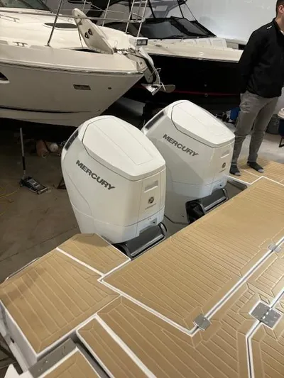  Yacht Photos Pics 2024 Cruisers Yachts 42 GLS with dual Mercury outboard engines in a showroom.