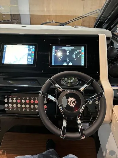  Yacht Photos Pics 2024 Cruisers Yachts 42 GLS helm with dual displays and modern steering wheel.