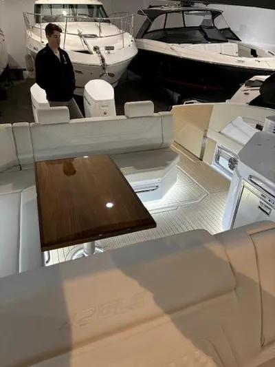  Yacht Photos Pics 2024 Cruisers Yachts 42 GLS interior with elegant seating and wooden table.