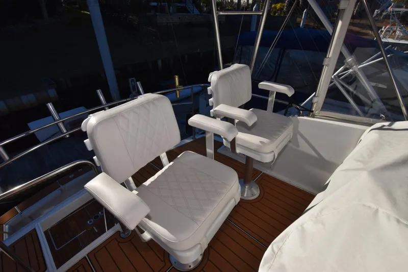 The Dog Patch Yacht Photos Pics Two white cushioned chairs on 1990 Ocean Yachts 48 Super Sport deck.