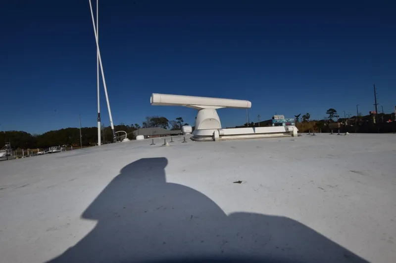 The Dog Patch Yacht Photos Pics 1990 Ocean Yachts 48 Super Sport yacht deck with radar equipment under clear blue sky.