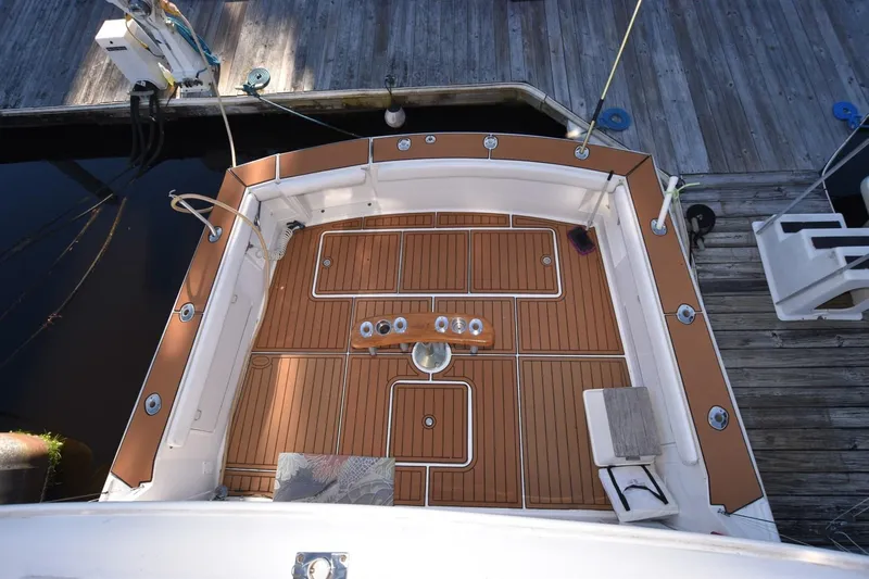 The Dog Patch Yacht Photos Pics 1990 Ocean Yachts 48 Super Sport deck with teak flooring, docked at marina.