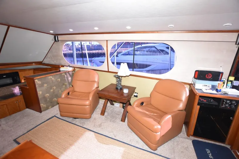 The Dog Patch Yacht Photos Pics Interior of 1990 Ocean Yachts 48 Super Sport with leather chairs and large windows.