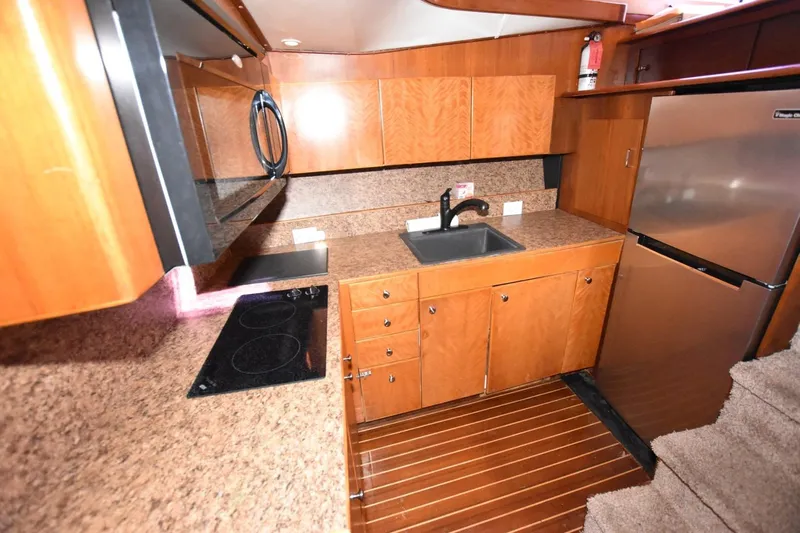 The Dog Patch Yacht Photos Pics 1990 Ocean Yachts 48 Super Sport kitchen with wood cabinets and modern appliances.