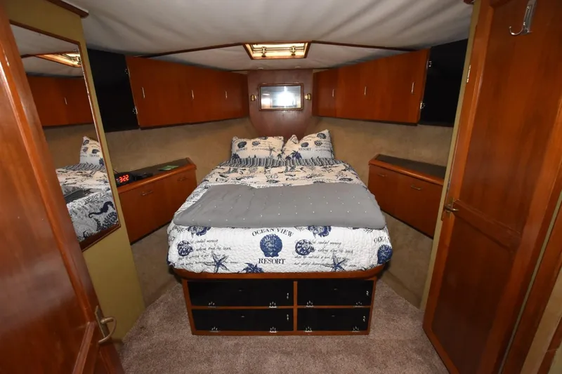 The Dog Patch Yacht Photos Pics Luxurious cabin interior of 1990 Ocean Yachts 48 Super Sport with cozy bedding.