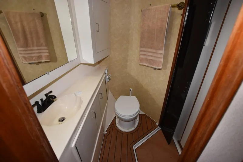 The Dog Patch Yacht Photos Pics Bathroom interior of 1990 Ocean Yachts 48 Super Sport, featuring sink and toilet.