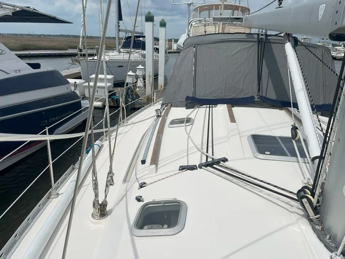 Sea Bear Yacht Photos Pics Jeanneau Sun Odyssey 45.2 sailboat docked, showcasing deck and rigging, 1998 model.