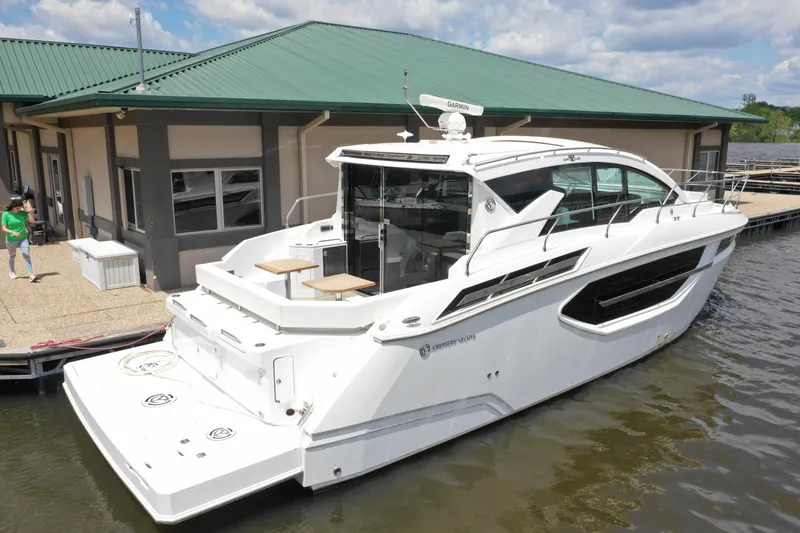  Yacht Photos Pics 2019 Cruisers Yachts 42 Cantius docked by a marina under a clear sky.