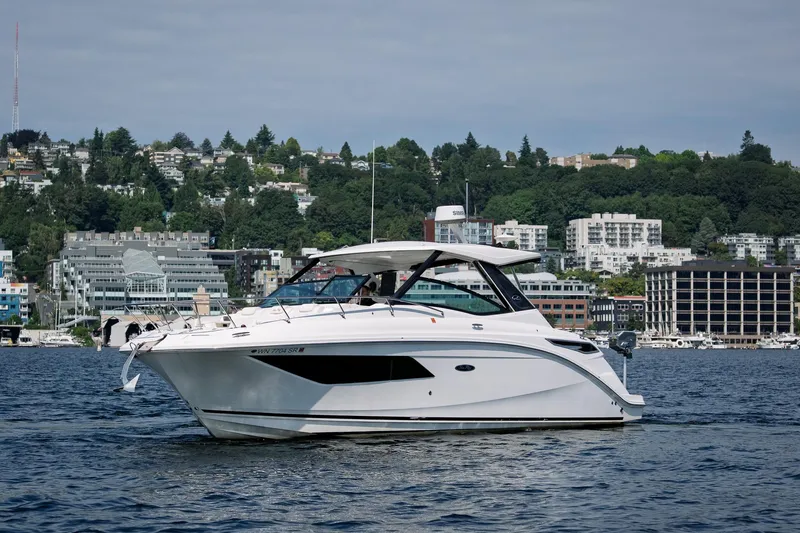  Yacht Photos Pics 2019 Sea Ray Sundancer 320 yacht cruising on a scenic waterfront.